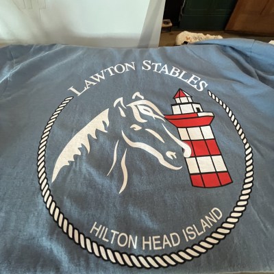 Blue shirt with horse outline and lighthouse logo for Lawton Stables, Hilton Head Island.